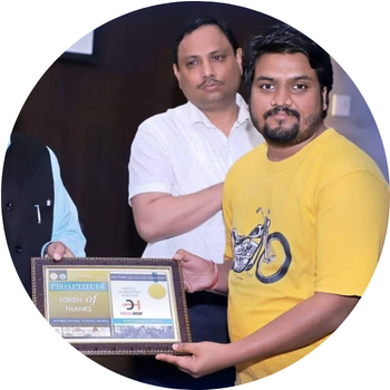Man in a yellow t-shirt receiving a framed "Token of Thanks" certificate as Digital Marketing Partner from Proaptitude.